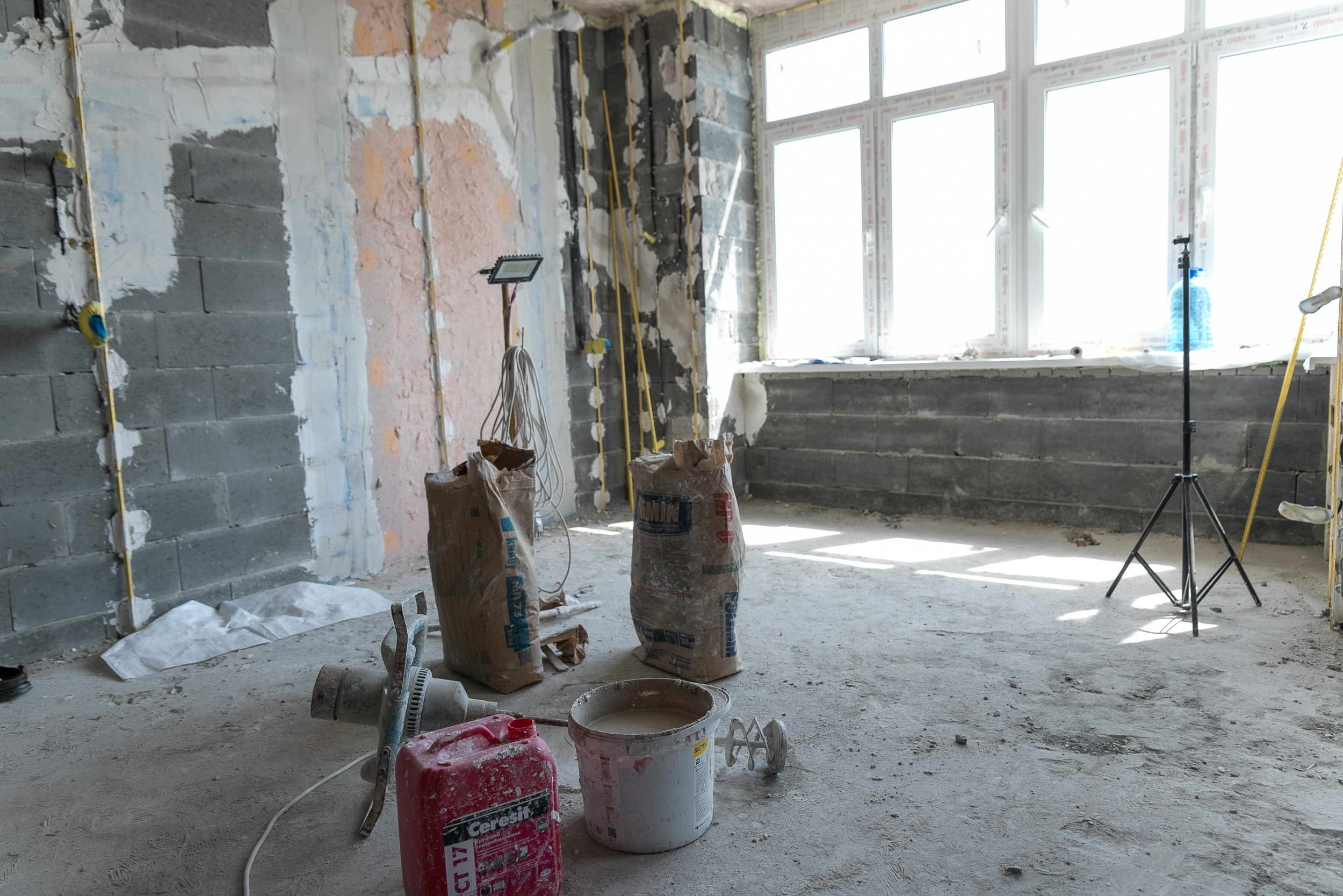 Unfinished residential interior with tools and new windows during repairs in Kyiv in August 2024
