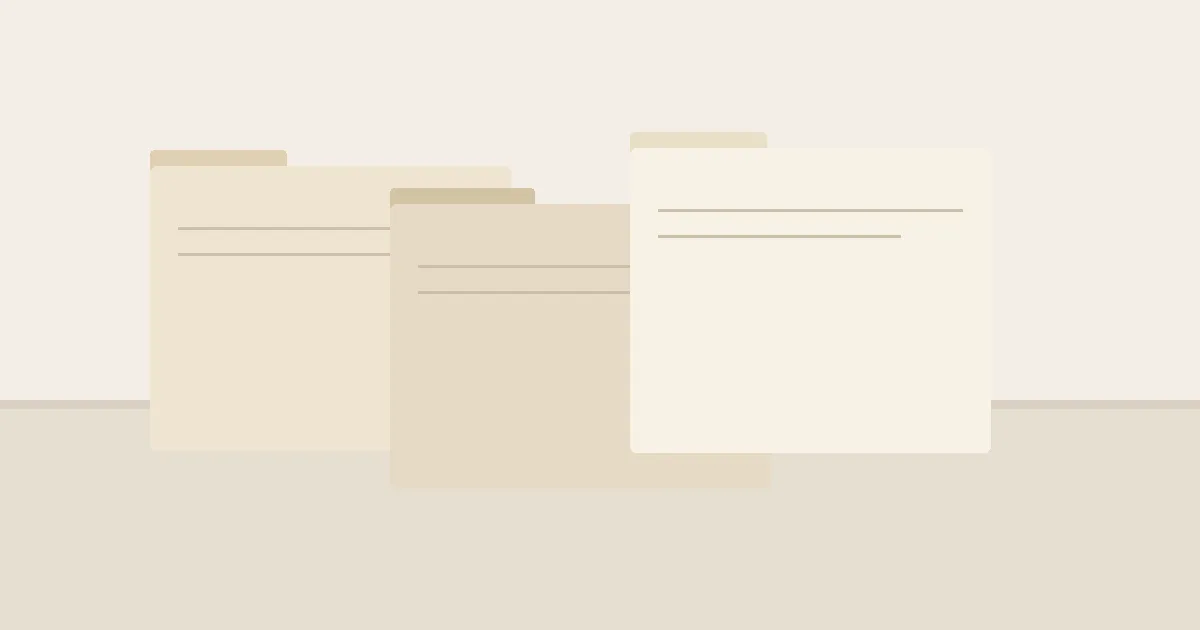 Three plain file folders overlapping on a bare table